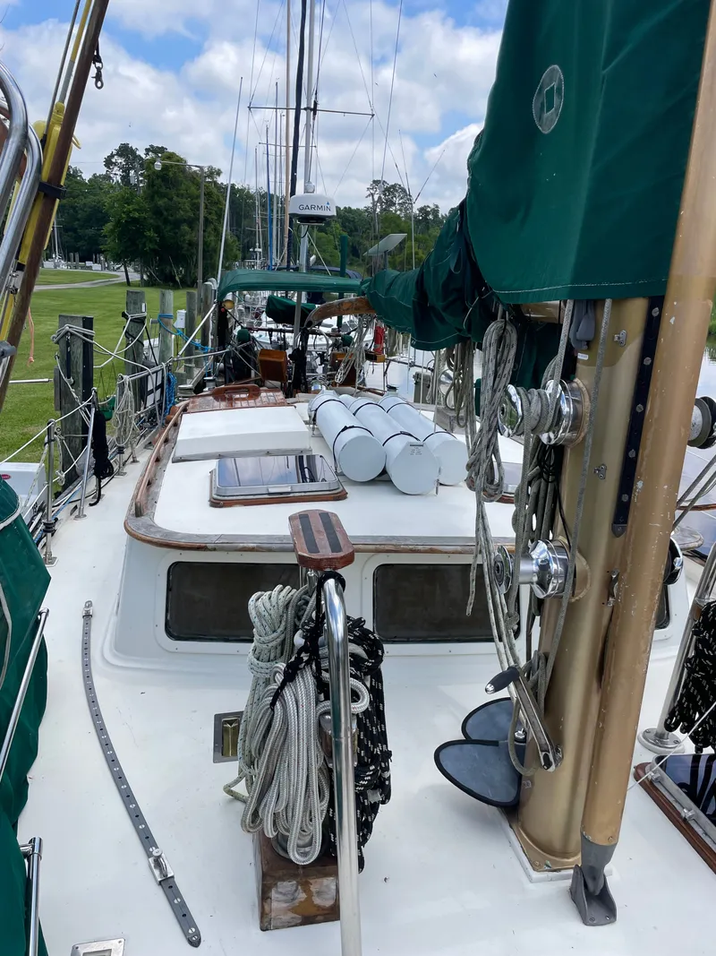 Slide: The Image of 1983 Formosa Spindrift 43 sailboat with green covers and ropes. - 6