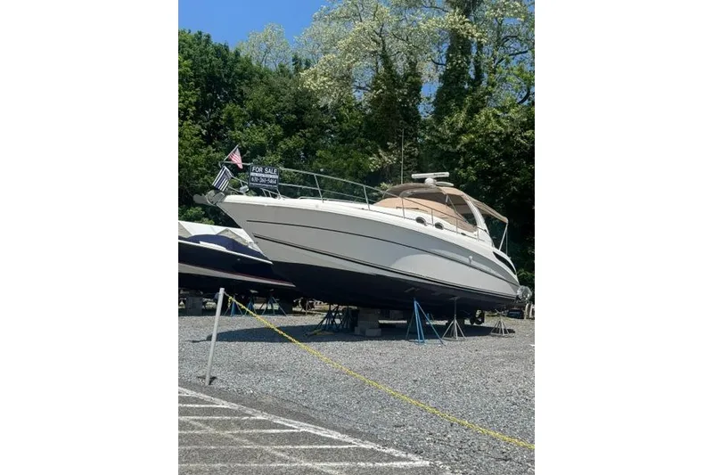 The Image of 2002 Sea Ray 360 Sundancer yacht for sale, displayed on land with trees in background. - 0