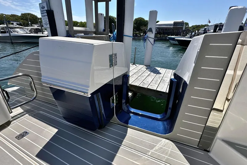 Slide: The Image of Tiara Yachts 56 LS 2027 model docked at a marina with wooden pier. - 10