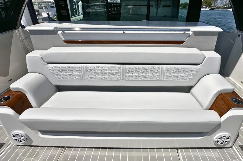 Slide: The Image of Luxurious seating on 2027 Tiara Yachts 56 LS, featuring elegant white upholstery and wood accents. - 12