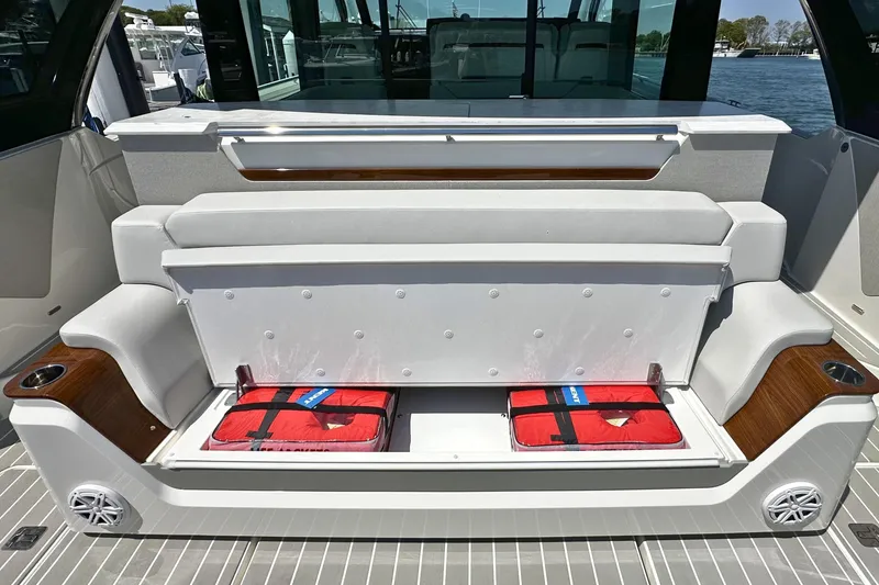 Slide: The Image of 2027 Tiara Yachts 56 LS seating with storage compartment and life jackets. - 13
