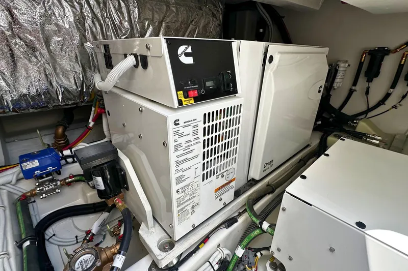Slide: The Image of Engine room of 2027 Tiara Yachts 56 LS featuring Cummins Onan generator. - 16