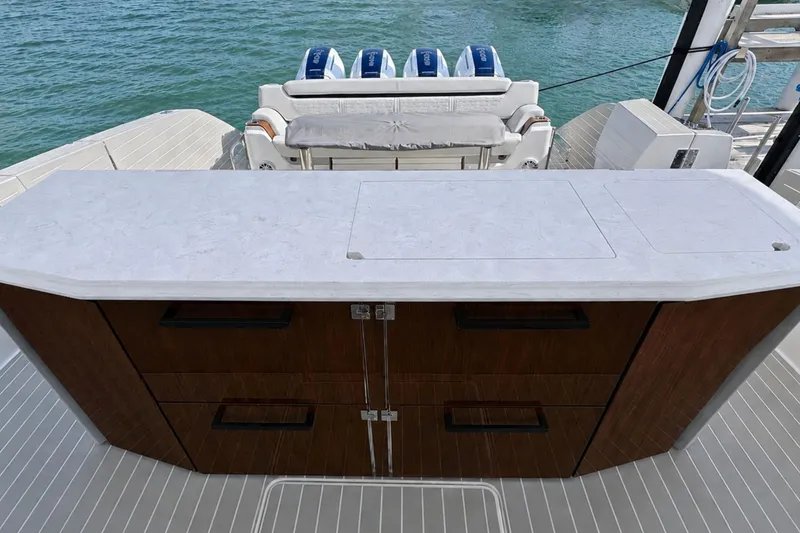 Slide: The Image of Luxury Tiara Yachts 56 LS 2027 model with sleek outdoor kitchen and ocean view. - 18