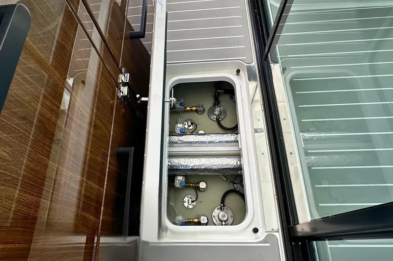 Slide: The Image of Engine compartment of 2027 Tiara Yachts 56 LS, showcasing mechanical components and sleek design. - 20