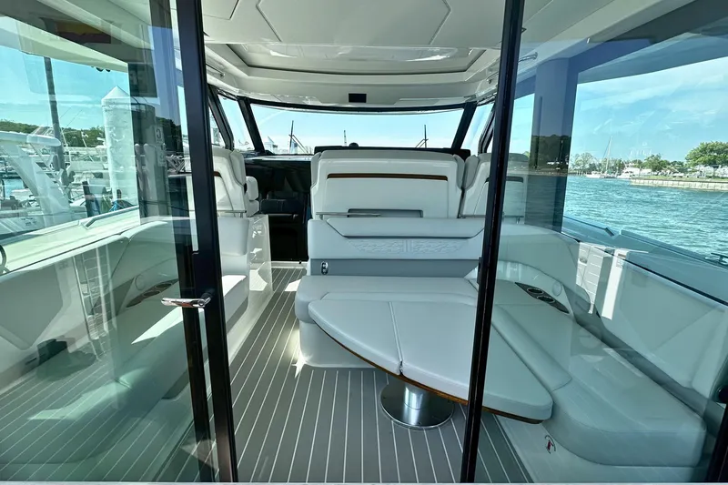 Slide: The Image of 2027 Tiara Yachts 56 LS interior with sleek seating and panoramic windows. - 21