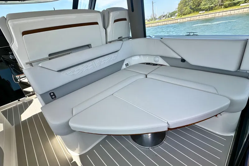 Slide: The Image of Luxurious seating area on the 2027 Tiara Yachts 56 LS, featuring elegant white upholstery. - 22