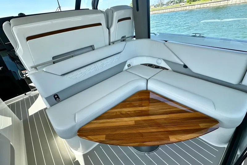 Slide: The Image of Luxurious seating area on 2027 Tiara Yachts 56 LS with elegant wooden table. - 23
