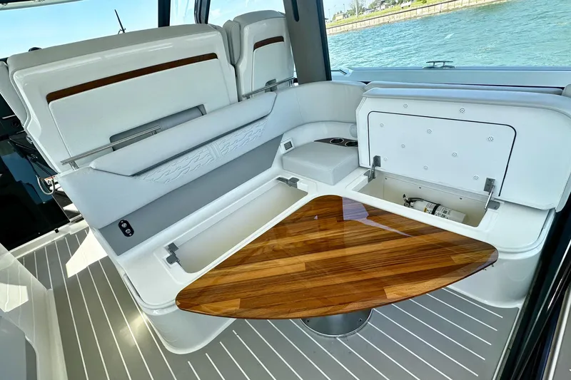 Slide: The Image of Luxurious interior of 2027 Tiara Yachts 56 LS with elegant wood table and seating. - 24