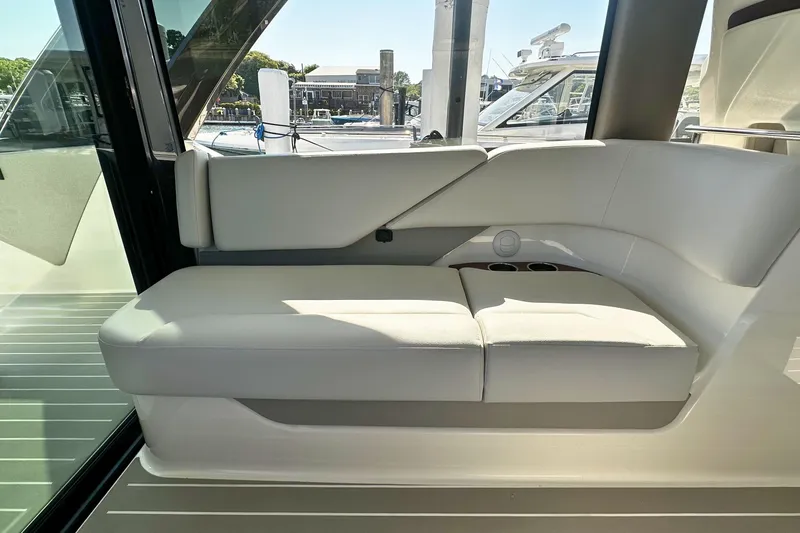 Slide: The Image of 2027 Tiara Yachts 56 LS interior seating, featuring sleek white upholstery and modern design. - 25