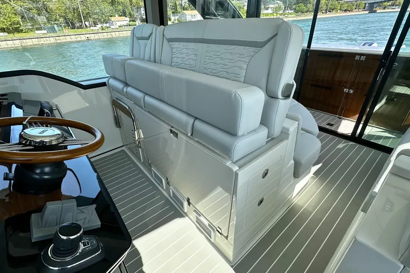 Slide: The Image of Luxurious interior of 2027 Tiara Yachts 56 LS with elegant seating and steering wheel. - 26