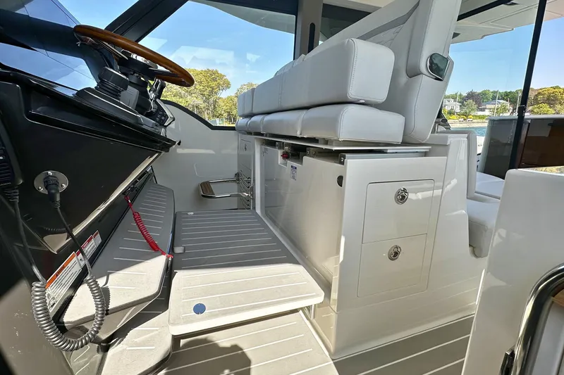 Slide: The Image of Interior of 2027 Tiara Yachts 56 LS, featuring sleek helm and seating area. - 28