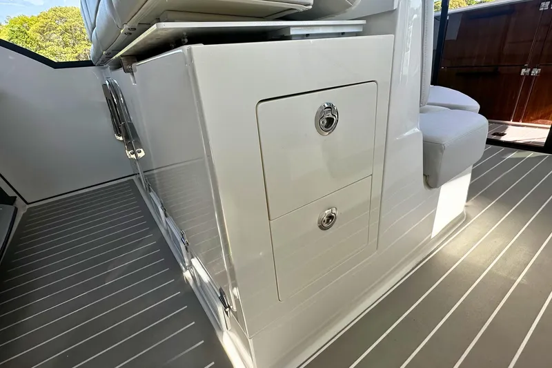 Slide: The Image of 2027 Tiara Yachts 56 LS interior with sleek storage compartments and modern seating. - 29