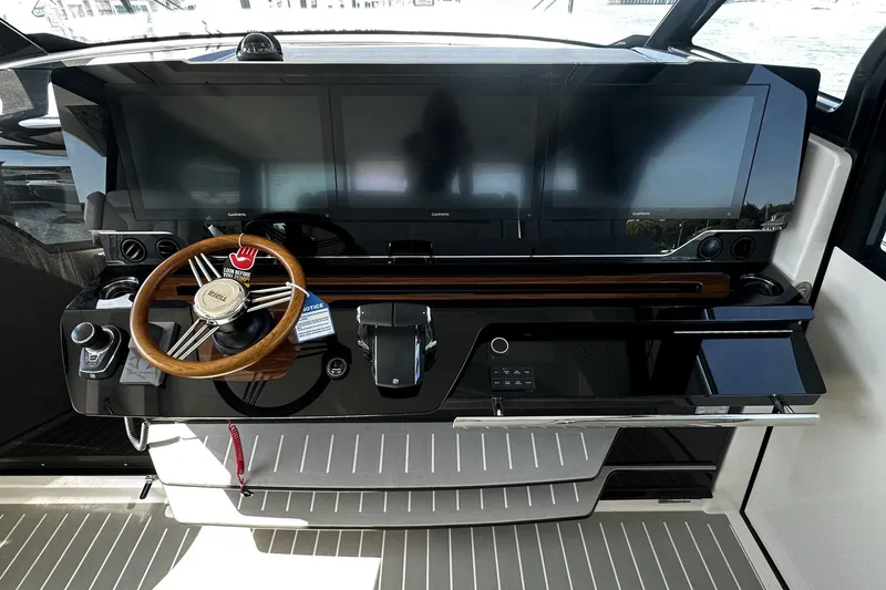 Slide: The Image of Helm of 2027 Tiara Yachts 56 LS with modern controls and dual displays. - 30