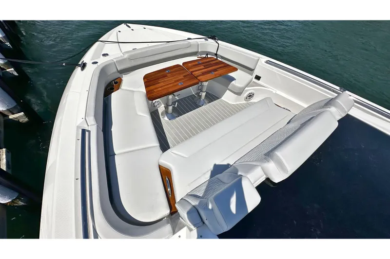 Slide: The Image of Luxurious seating area on 2027 Tiara Yachts 56 LS, featuring elegant wooden tables. - 33