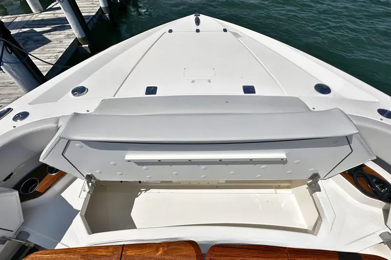 Slide: The Image of Bow seating area on a 2027 Tiara Yachts 56 LS, docked by the water. - 36