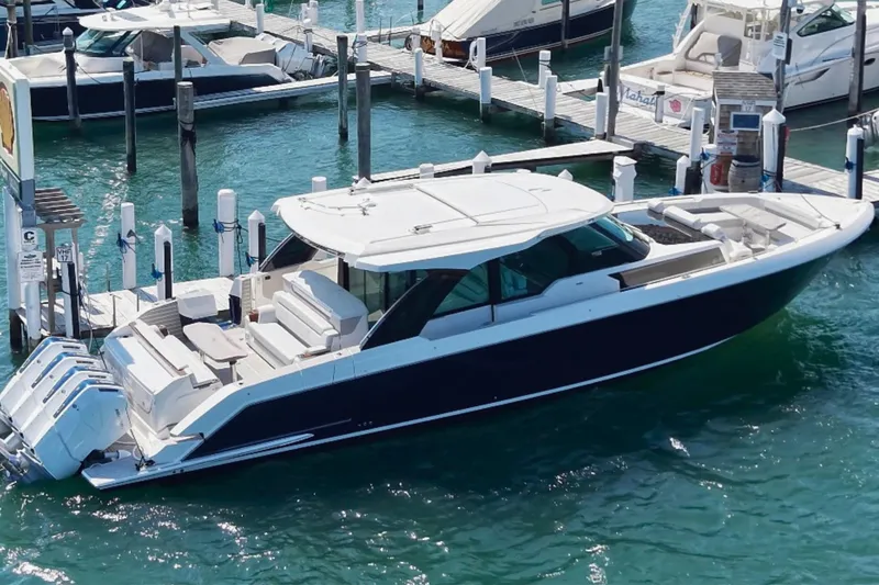 Slide: The Image of 2027 Tiara Yachts 56 LS luxury boat docked in marina, featuring sleek design and powerful engines. - 4