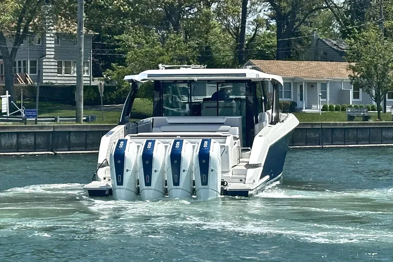 Slide: The Image of 2027 Tiara Yachts 56 LS with quad engines cruising on a sunny day. - 6