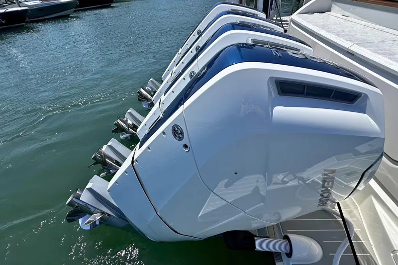 Slide: The Image of Four powerful outboard engines on a 2027 Tiara Yachts 56 LS, docked in water. - 7