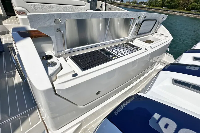 Slide: The Image of 2027 Tiara Yachts 56 LS yacht with outdoor kitchen and Mercury engines. - 9