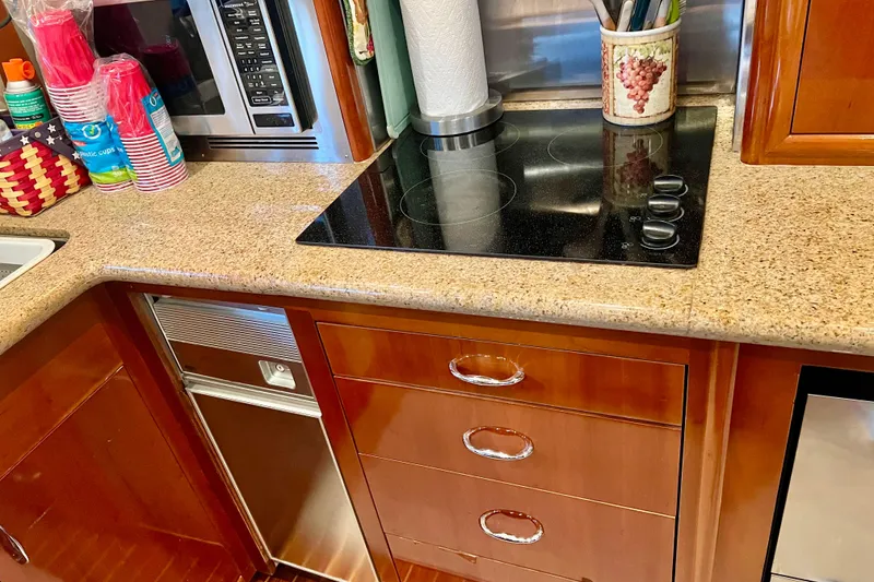 Slide: The Image of Kitchen area of a 2005 Carver 56 Voyager yacht with stove and microwave. - 10