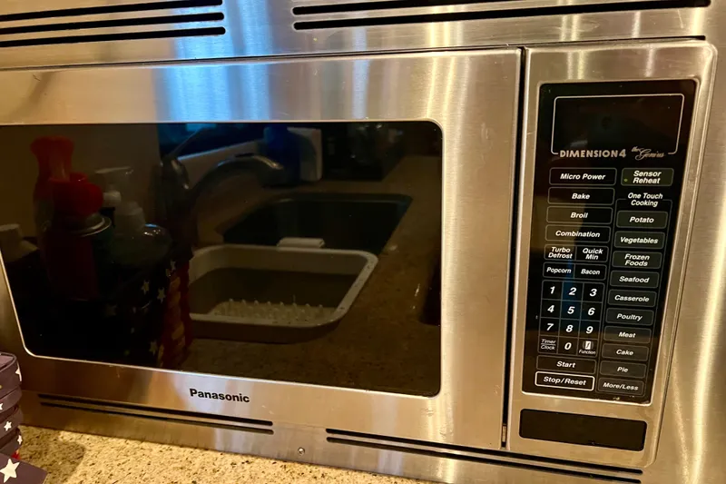Slide: The Image of Panasonic Dimension4 microwave with various cooking options, set in a kitchen environment. - 11