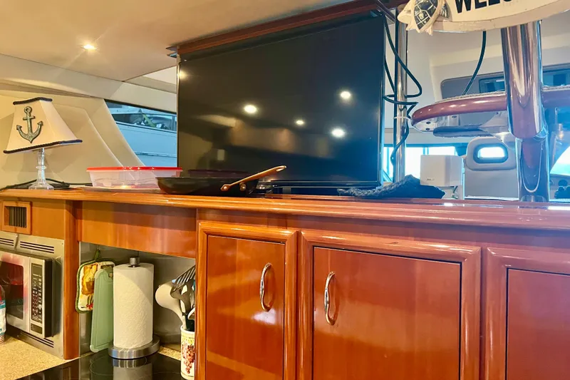 Slide: The Image of Interior of 2005 Carver 56 Voyager yacht with wooden cabinetry and modern amenities. - 14