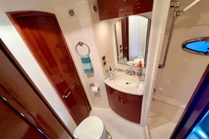 Slide: The Image of Luxurious bathroom in 2005 Carver 56 Voyager yacht with wood accents and modern fixtures. - 22