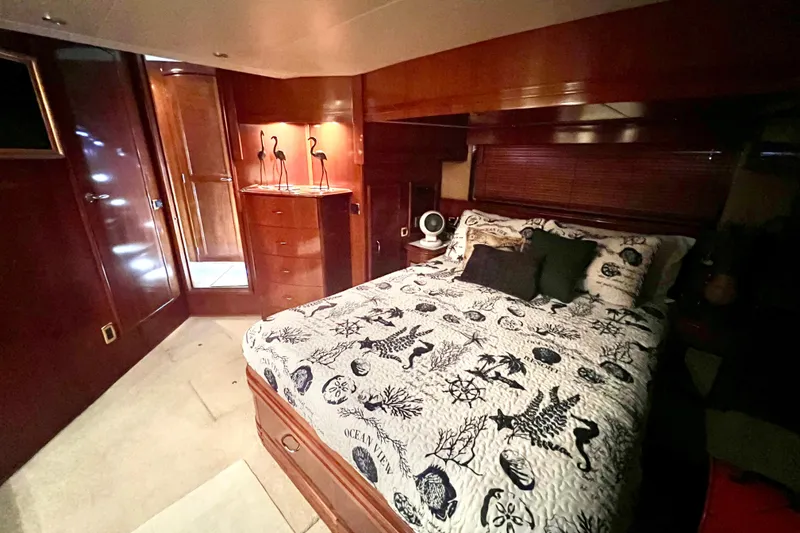 Slide: The Image of Luxurious bedroom interior of 2005 Carver 56 Voyager yacht with nautical-themed bedding. - 26