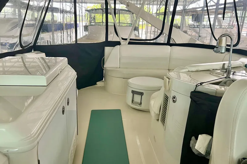 Slide: The Image of Interior of a 2005 Carver 56 Voyager yacht with white seating and modern amenities. - 32