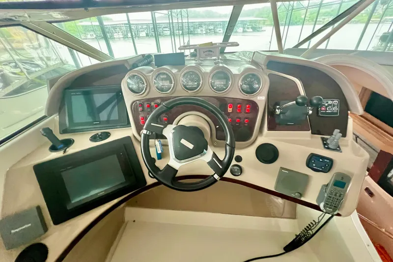 Slide: The Image of Helm of 2005 Carver 56 Voyager yacht with steering wheel and navigation controls. - 35