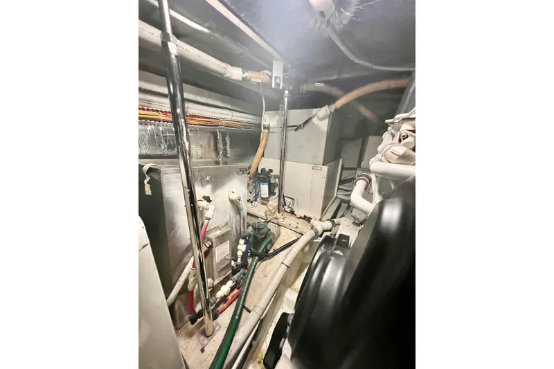 Slide: The Image of Engine room of a 2005 Carver 56 Voyager yacht, showcasing mechanical components. - 41