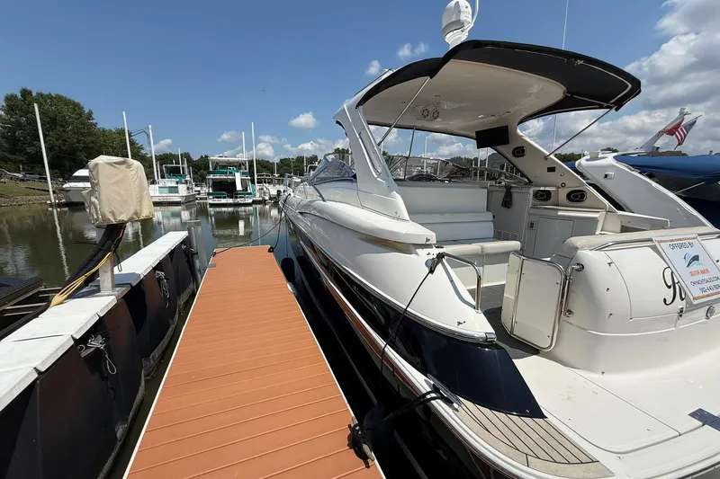 Slide: The Image of 2003 Regal Commodore 4260 yacht docked at marina under clear blue sky. - 1