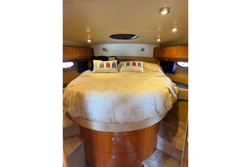 Slide: The Image of Luxurious cabin interior of 2003 Regal Commodore 4260 yacht with cozy bed and ambient lighting. - 13
