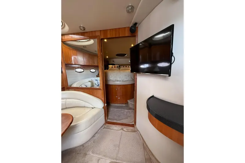 Slide: The Image of Interior of 2003 Regal Commodore 4260 yacht with TV, seating, and cozy cabin. - 14