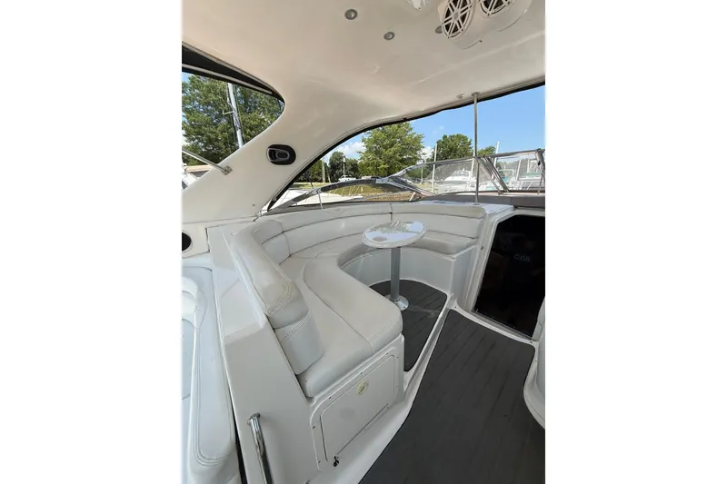 Slide: The Image of Luxurious interior of 2003 Regal Commodore 4260 yacht with white seating and table. - 2