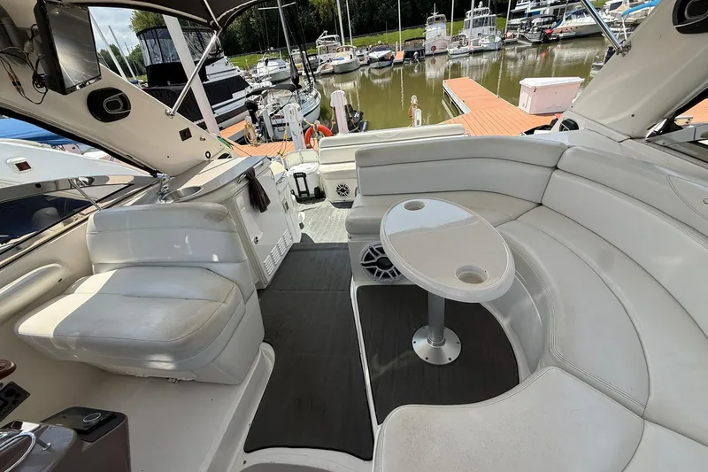 Slide: The Image of Luxurious 2003 Regal Commodore 4260 yacht interior with white seating and table at marina. - 3