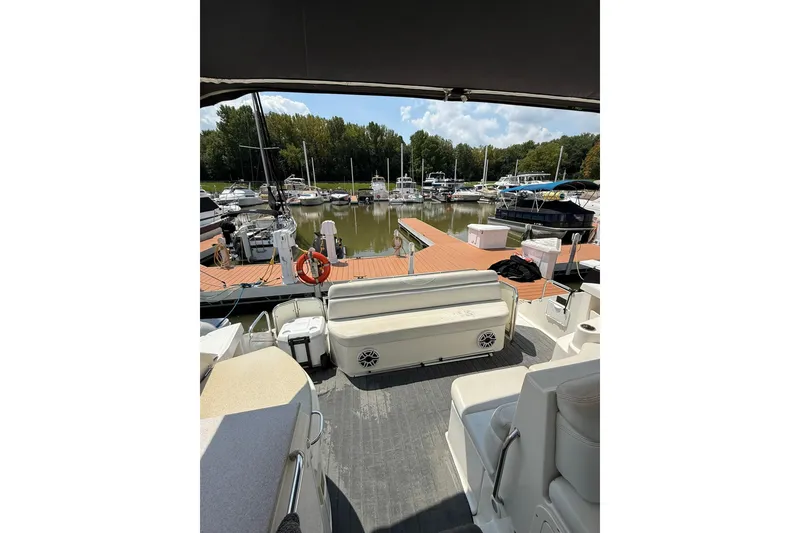 Slide: The Image of 2003 Regal Commodore 4260 yacht docked at a marina with surrounding boats. - 4