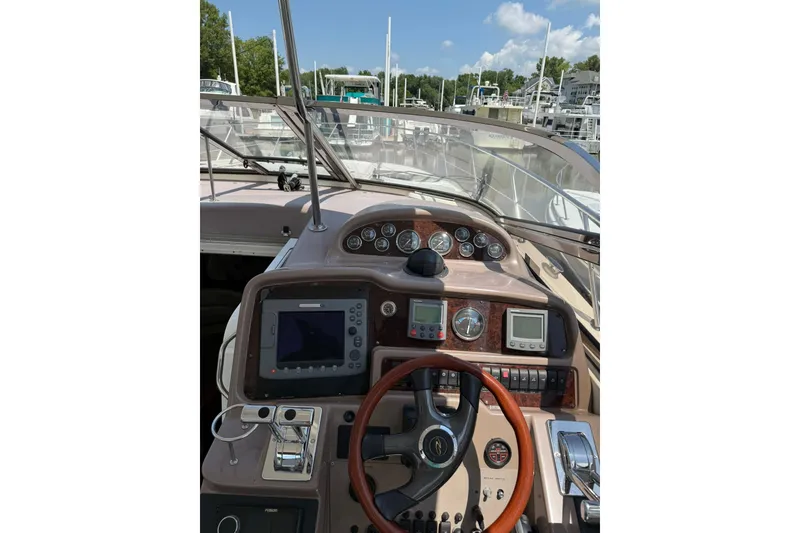 Slide: The Image of Cockpit view of 2003 Regal Commodore 4260 yacht with navigation instruments and steering wheel. - 5