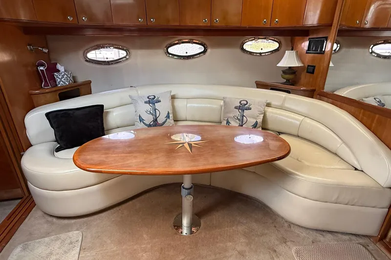 Slide: The Image of Luxurious 2003 Regal Commodore 4260 yacht interior with curved leather seating and nautical decor. - 7