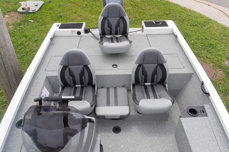 Slide: The Image of 2026 G3 Sportsman 1610 boat interior with four gray seats on a grassy background. - 12