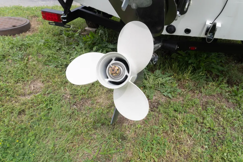Slide: The Image of 2026 G3 Sportsman 1610 boat propeller on grassy ground. - 2