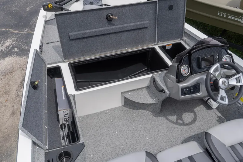Slide: The Image of 2026 G3 Sportsman 1610 boat interior with storage compartments and steering console. - 7