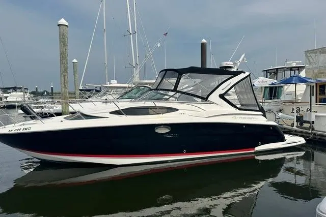 The Image of 2005 Regal 3360 Window Express boat docked in marina, featuring sleek design and black hull. - 0