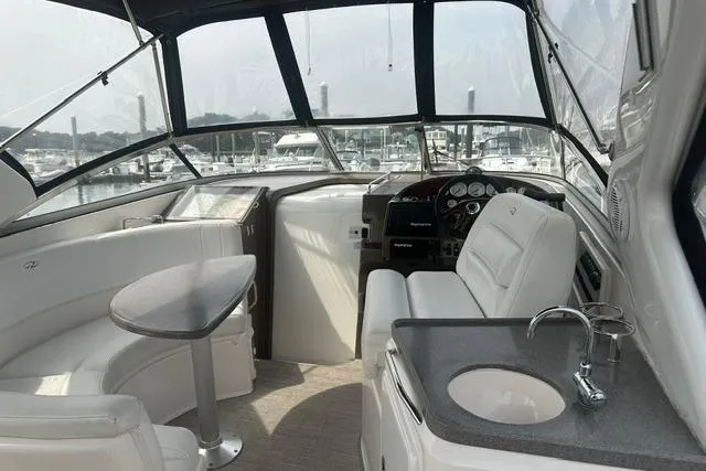 Slide: The Image of Interior of 2005 Regal 3360 Window Express yacht with seating, table, and helm. - 10