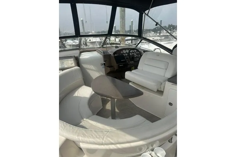 Slide: The Image of Interior of 2005 Regal 3360 Window Express yacht with white seating and helm. - 11
