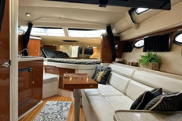 Slide: The Image of Luxurious interior of a 2005 Regal 3360 Window Express yacht with elegant seating and decor. - 17