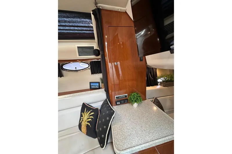 Slide: The Image of Interior of 2005 Regal 3360 Window Express yacht with cushions and decor. - 19
