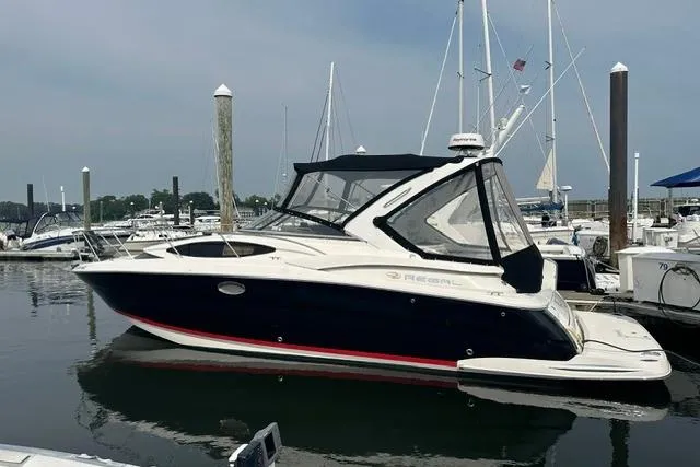 Slide: The Image of 2005 Regal 3360 Window Express boat docked in a marina. - 2