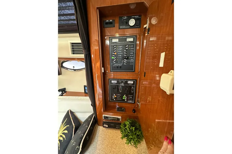 Slide: The Image of 2005 Regal 3360 Window Express control panel with switches and gauges in cabin interior. - 20