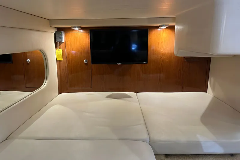 Slide: The Image of Interior of 2005 Regal 3360 Window Express yacht with TV and cushioned seating. - 22